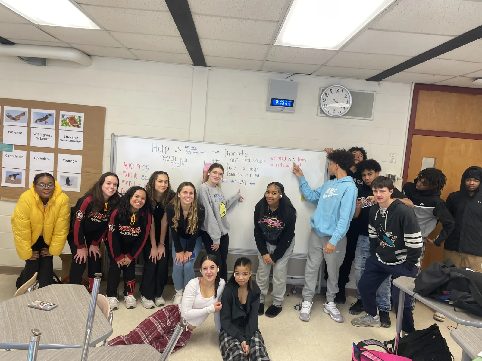 Students gathered in a gym around a hand-painted welcome banner